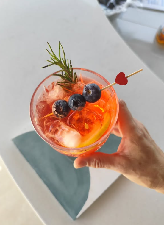The Naia Spritz, garnished with rosemary and blueberries